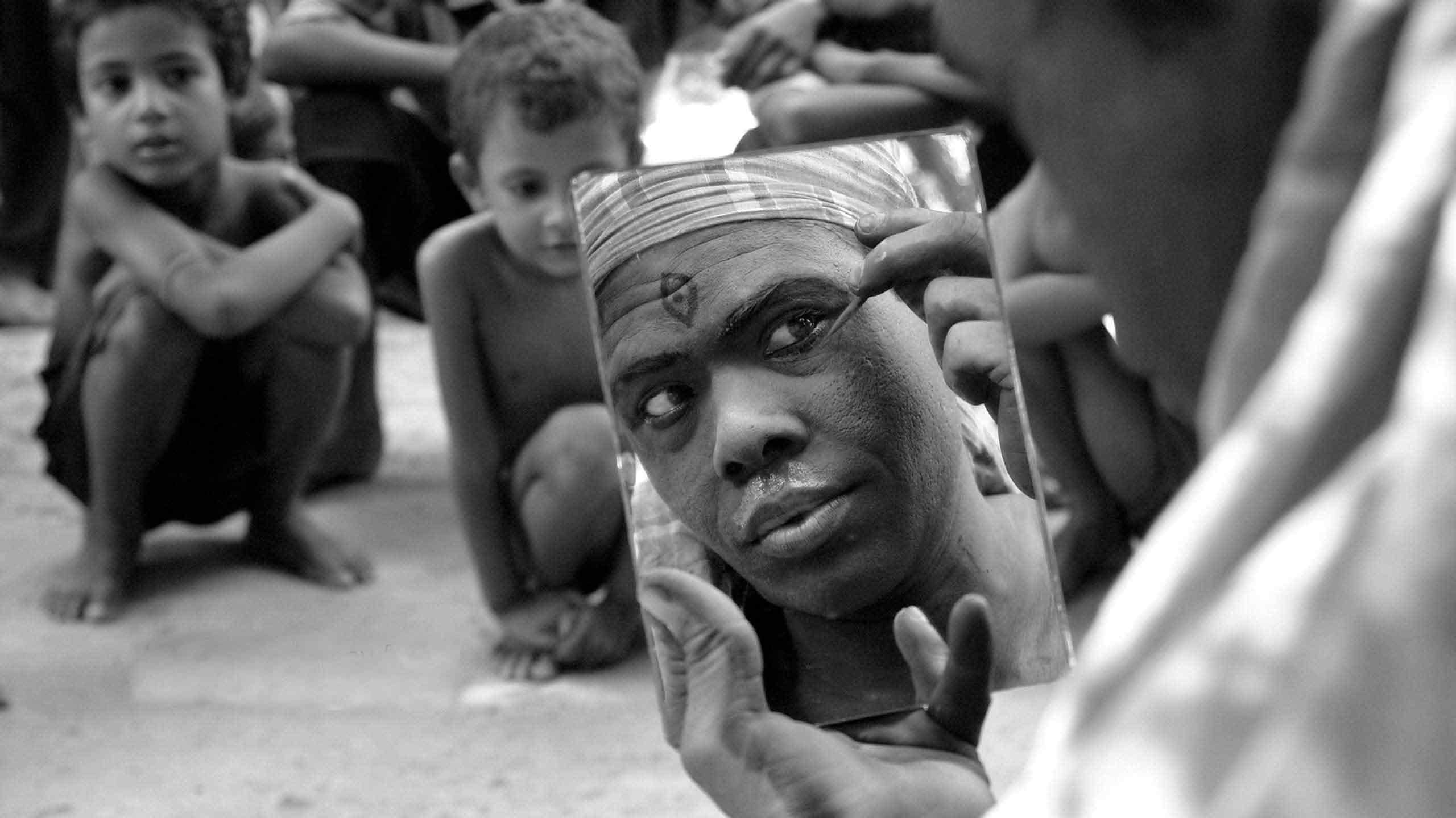 An image of a man getting dressed as a bohurupi.