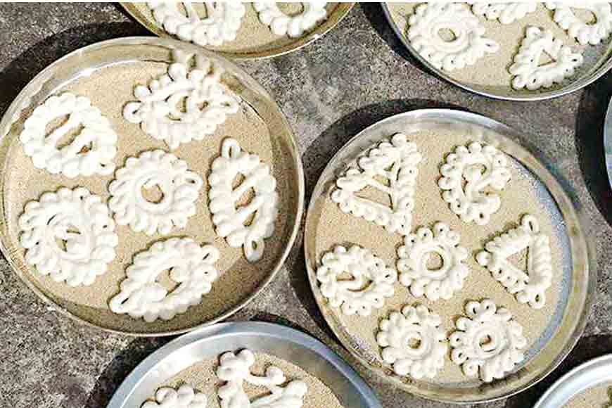 Fragile Bengali snacks crafted with designs of an alpona – dying art of Goyna Bori